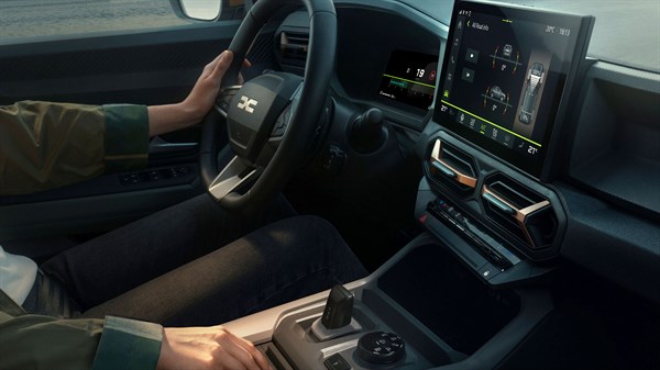 Notranjost vozila Dacia z volanom in zaslonom z prikazom mild hybrid sistema