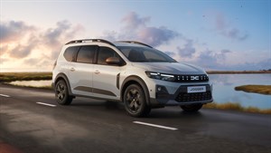 Beli Dacia Jogger na cesti skozi ob jezeru.