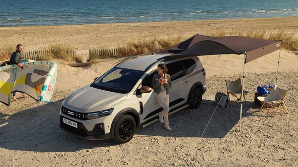 Sivi Dacia Jogger s šotorom na plaži.