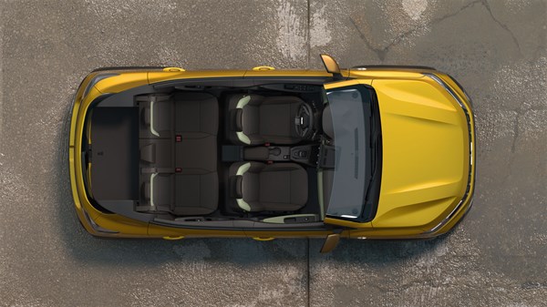 Na sliki je rumena Dacia Sandero Stepway, fotografirana od zgoraj, kar omogoča jasen pregled nad celotno notranjostjo. Vidni so vsi sedeži, razporejeni v dveh vrstah, ter prtljažni prostor v zadnjem delu.